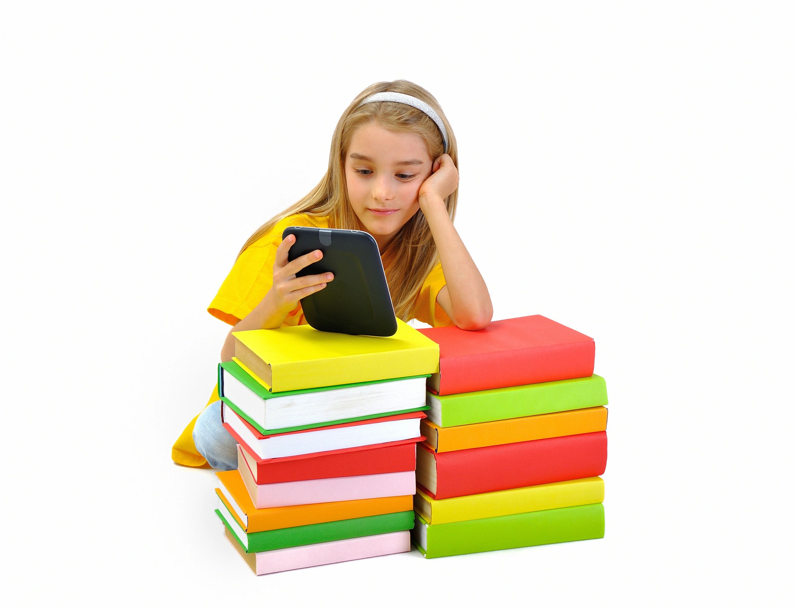 Little girl, books and ebook reader, isolated on background.